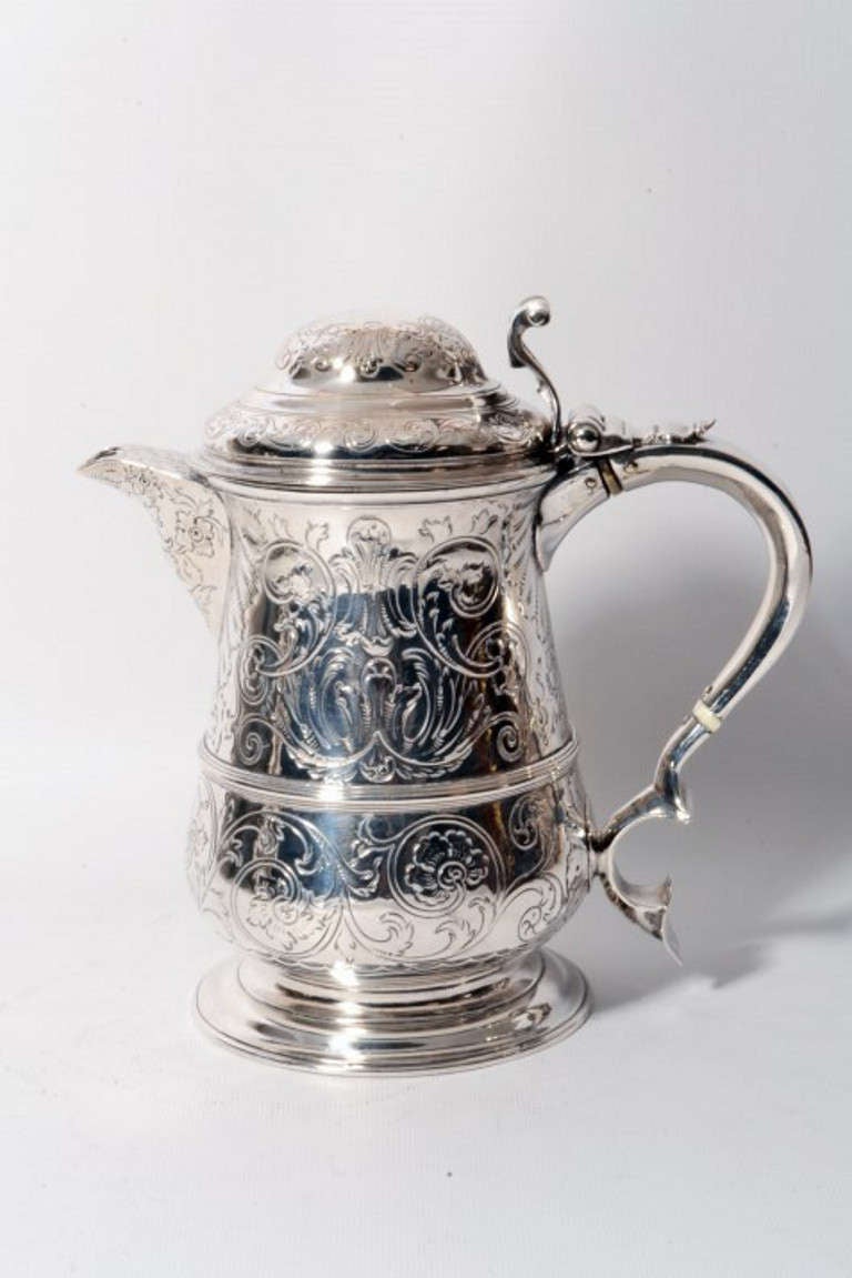 This is wonderful antique English George II sterling silver lidded tankard with lip. It has hallmarks for London 1760. 

The maker's mark is from the renowned silversmiths Richard Gurney & Thomas Cook of London. 

The tankard is embossed and