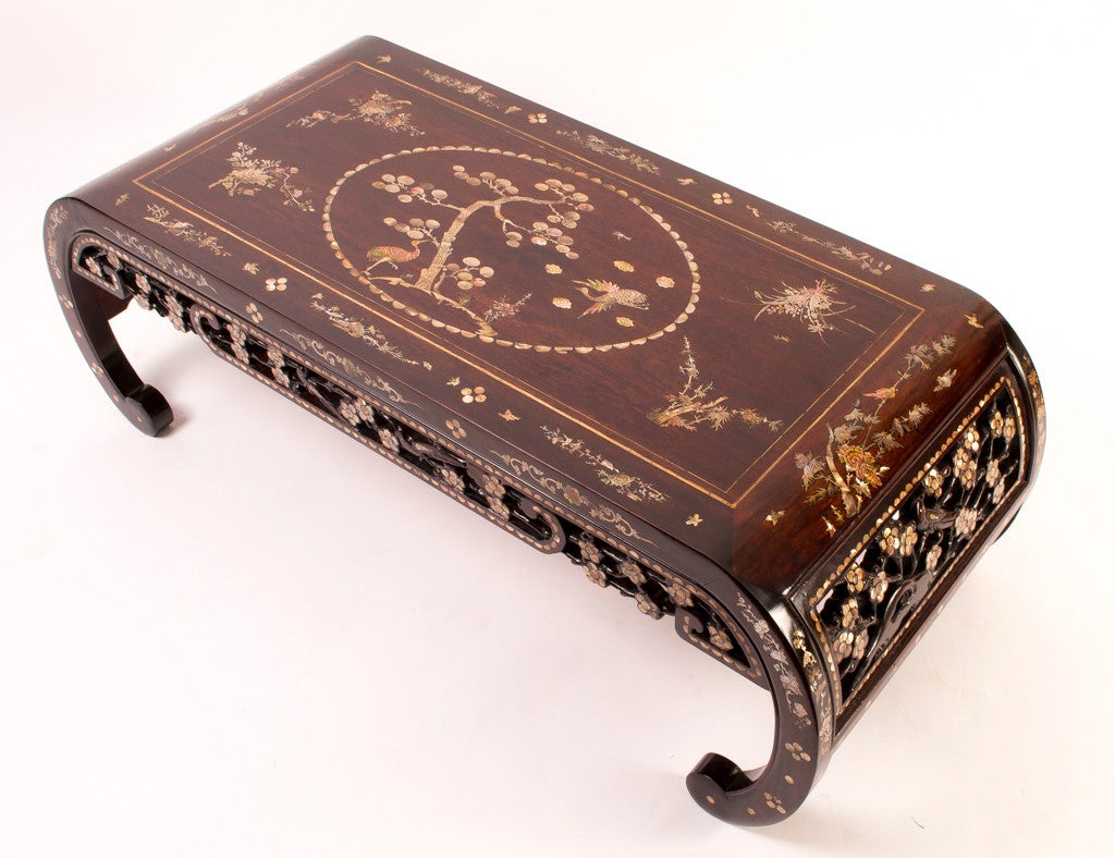 This is a vintage Chinese rosewood and mother of pearl inlaid opium table, perfect as a coffee table, dating from the first half of the 20th Century. 

The solid rosewood was expertly inlaid with a fabulous marquetry of mother of pearl, showing