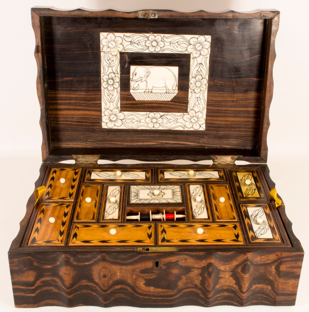 This is a fabulous antique Ceylonese coromandel work box, circa 1880 in date. 

The casket is of rectangular form with sinuous serpentine edges. The hinged lid is beautifully inlaid with a superb panel of an elephant with foliate borders. There is