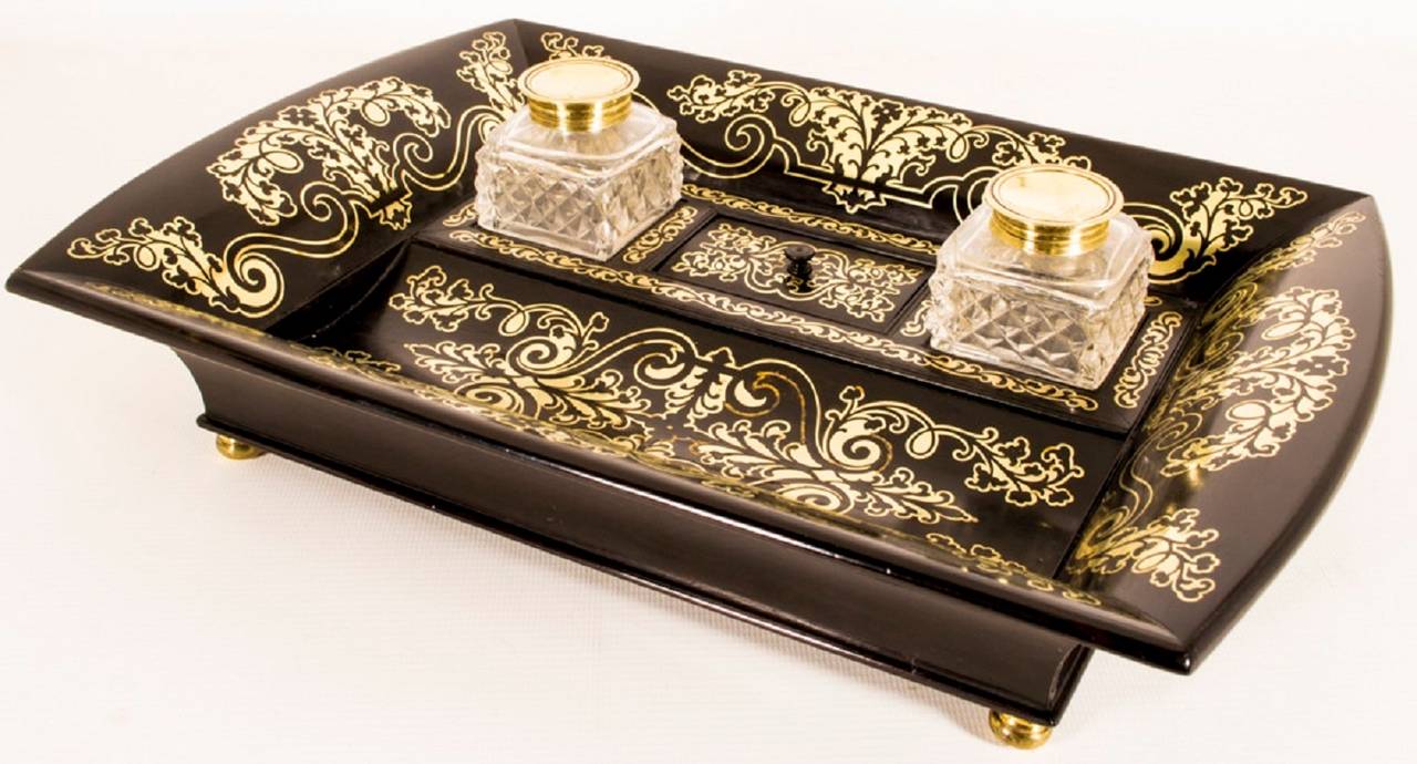 This is a lovely antique French coromandel wood and cut brass Boulle work ink stand, circa 1840 in date and made in the manner of George Bullock. 

The encrier comprises two glass inkwells with a sunken well with a lid. The set features exquisite