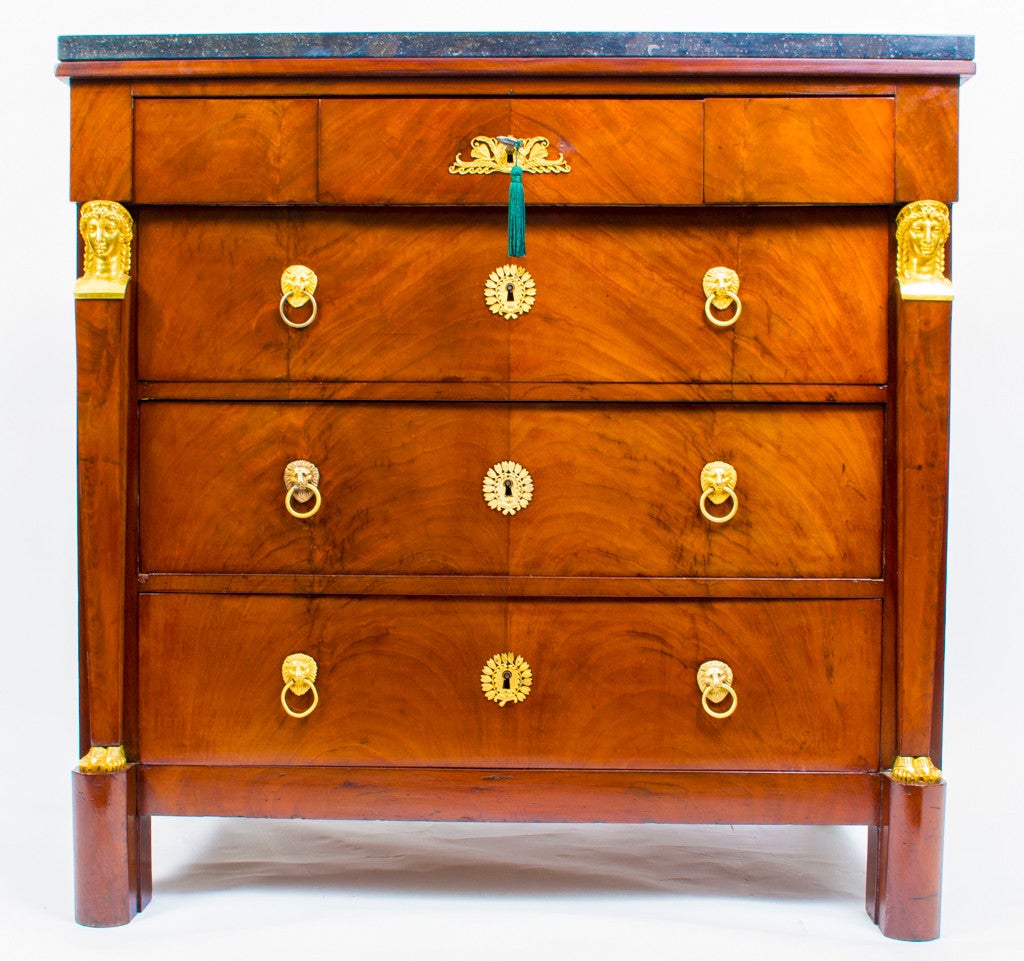 This stunning antique French Empire chest which was crafted from the most beautiful flame mahogany dates from circa 1820. 

The commode has three drawers in the frieze with three capacious full width drawers below. It has the most wonderful ormolu