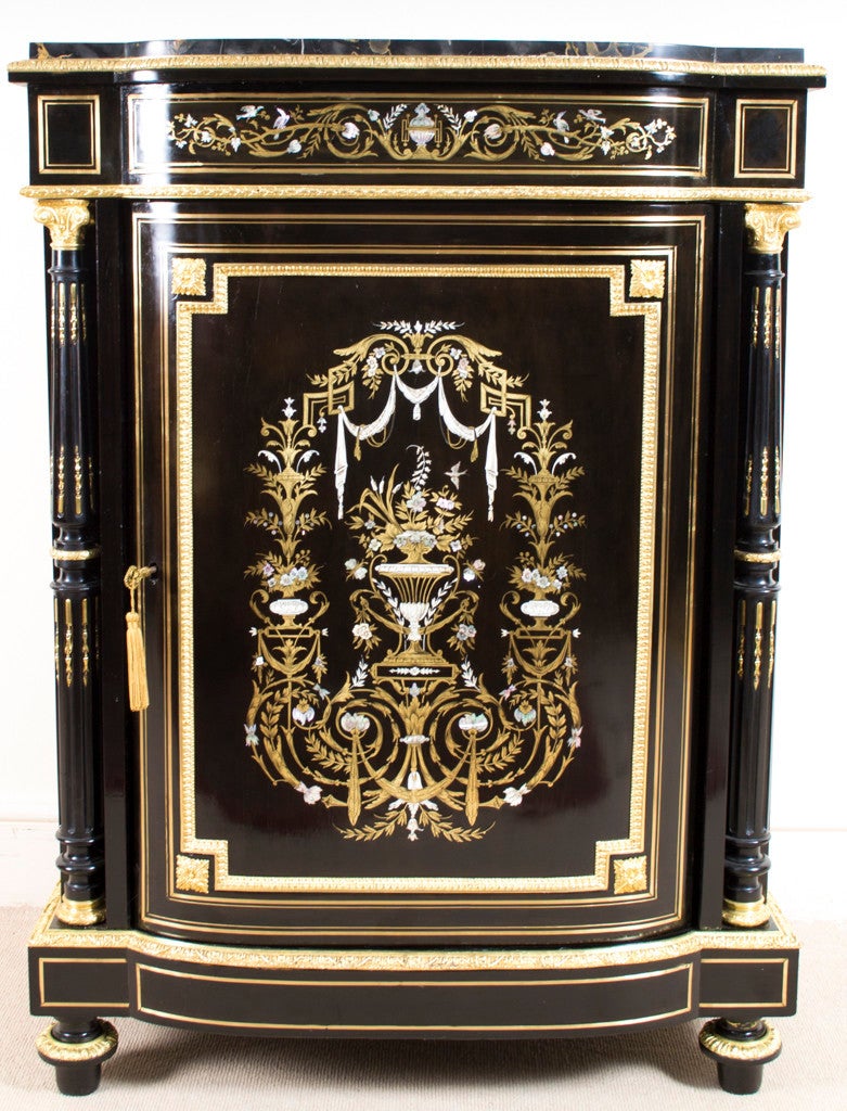 This is a unique, antique Napoleon III ebonised and ormolu mounted, abalone, brass and mother of pearl pier cabinet c.1860. 

This beautiful cabinet is of bow fronted form and is profusely inlaid with flower-filled urns, birds, ribbon-tied