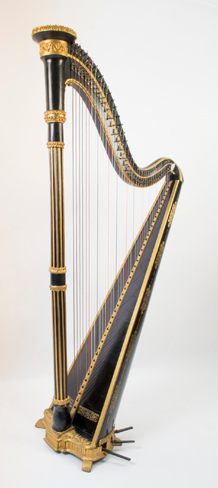 This is a stunning, French antique, ebonised parcel gilt harp, with brass inlay, circa 1780 in date. 

This instrument is a single action hook harp, built Circa 1780 in Paris France. It uses the pedal-system Hochbrucker in Austria had invented to