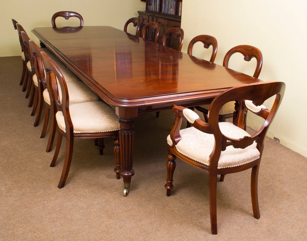 This is a vintage Victorian style mahogany dining set which comprises of: 
* dining table and 
* twelve chairs 

The table can seat twelve in great comfort and would also be perfect as a conference table. 

This flame mahogany dining table has