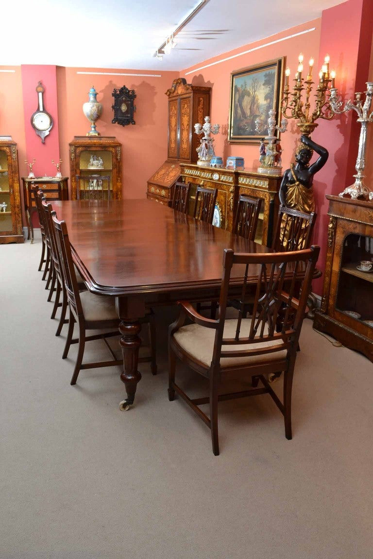 There is no mistaking the style and sophisticated design of this exquisite English Victorian mahogany extending dining table, circa 1870 in date, and set of ten solid mahogany vintage arrowack dining chairs.. This stunning set will stand out in your