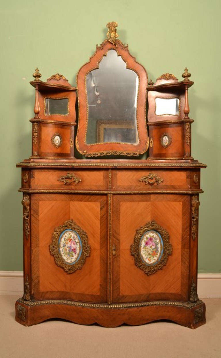 This is a gorgeous Antique French serpentine fronted tulipwood and kingwood dressing table with Sevres porcelain plaques, in the Louis XV style, circa 1850 in date. 

It is made from tulipwood with kingwood crossbanded decoration, has oval hand