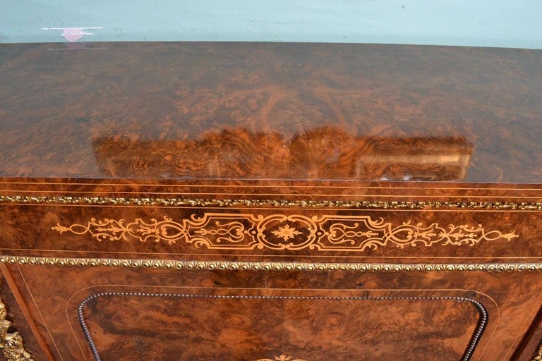 This is a superb antique Victorian burr walnut inlaid credenza, circa 1860 in date . Oozing sophistication and charm, this credenza is the absolute epitome of Victorian high society. Its attention to detail and lavish decoration are certain to draw
