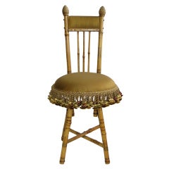 1940's bamboo boudoir chair with silk upholstery and fringe