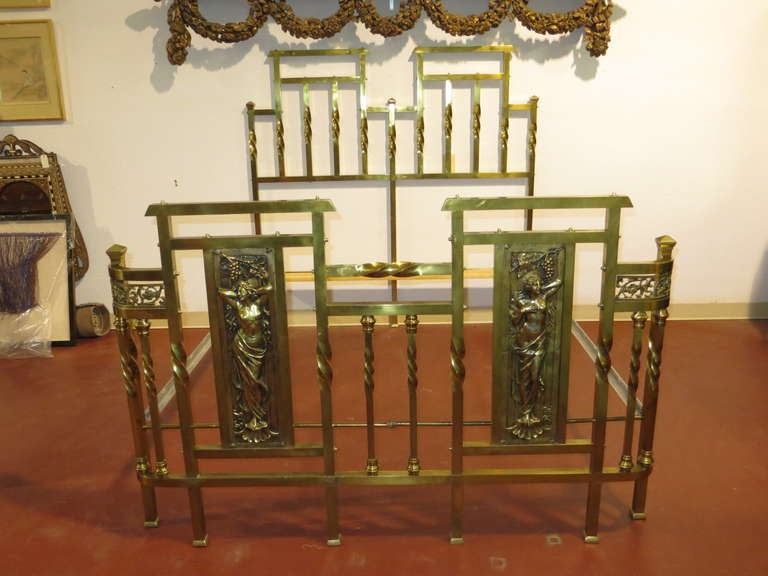 Art Nouveau solid brass with turnings on sides and 2 motifs of ladies of the period queen size bed. 
