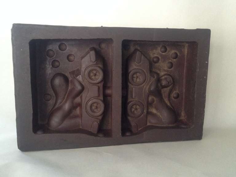 Soft rubber die mold, depicting a woman and a sports car. Used for creating molds for injection molded multiples. Rather unique..