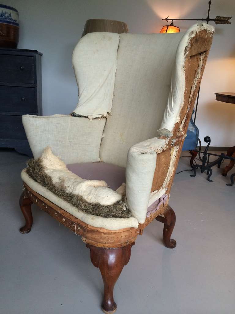 Wonderful American Queen Anne period wing chair. Beautifully proportioned and a visual treat from every angle. Scrolls and curves balance gracefully. The rear legs tip in at the ankles to exagerate a forward thrust. Personifies the austere granduer