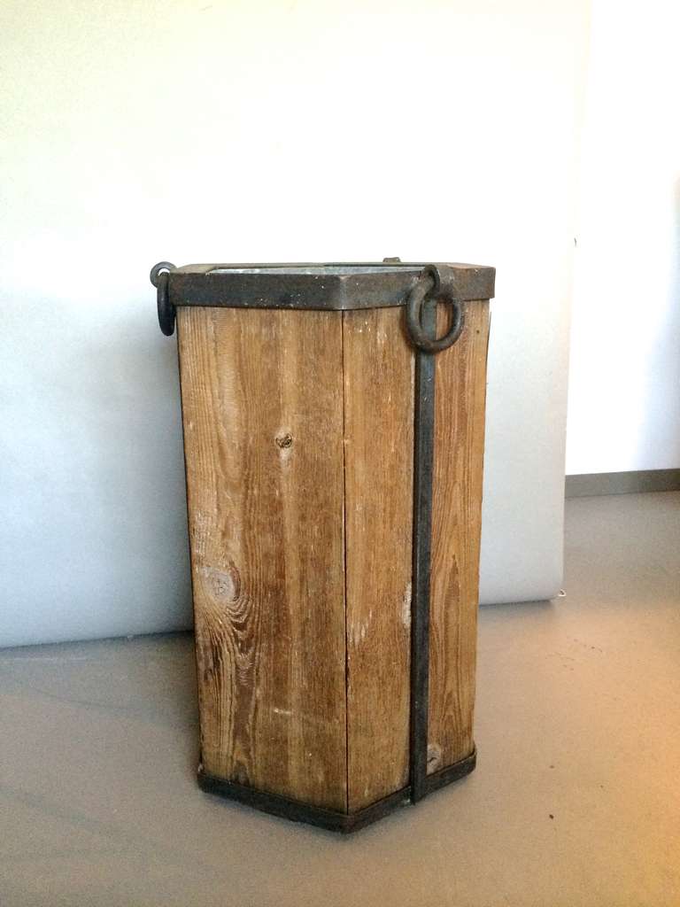 Hexagonal planter from a lodge in Lake Arrowhead Ca., from the early 20th century. Wrought and machined iron mixed with Cypress wood slabs and well crafted tin interior.