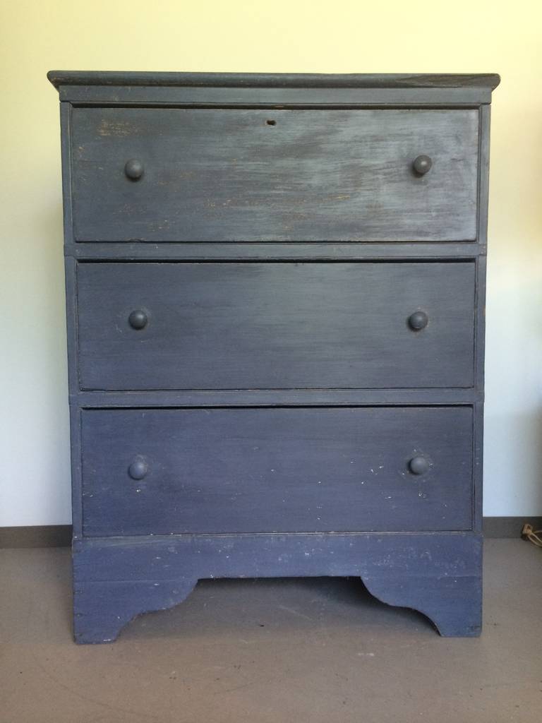A three-drawer chest in blue milk paint surface with wonderful proportions. New York state 18th century origin with simple severe styling reminiscent of the Shakers.