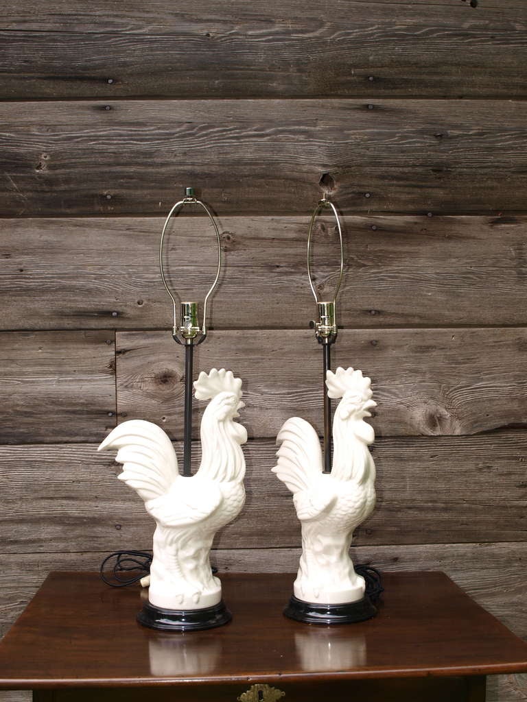 A matched pair of cast and fire glazed porcelain lamps, depicting proud roosters. Fine casting, with flowing design, and strong, natural porcelain color.