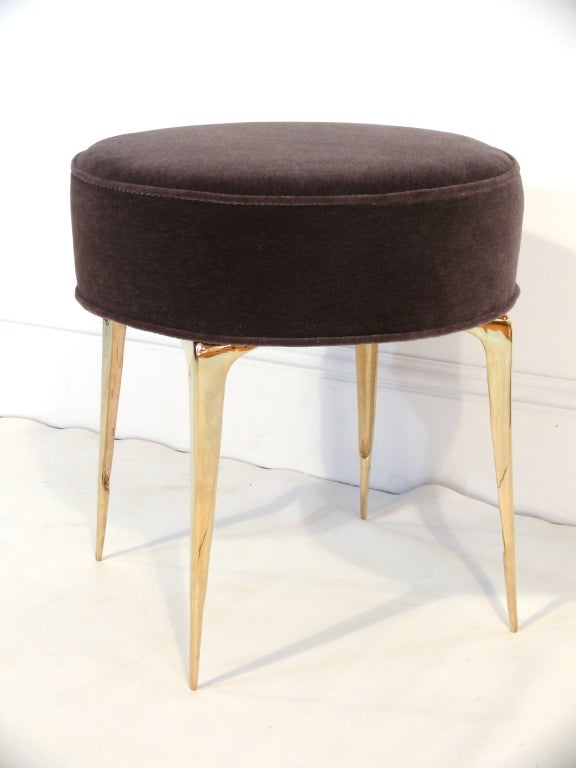 The Round Stiletto Ottoman designed by Irwin Feld Design for CF Modern.  
These ottomans feature four of our hand cast and hand polished brass sculptural 