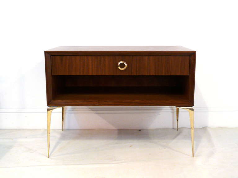 A custom Mid-Century inspired Ellie Stiletto stand designed by Irwin Feld Design for CF Modern. Hand cast and hand polished, solid brass legs are elegantly tapered and support a walnut cabinet which is stained in a natural walnut. The cabinet has a