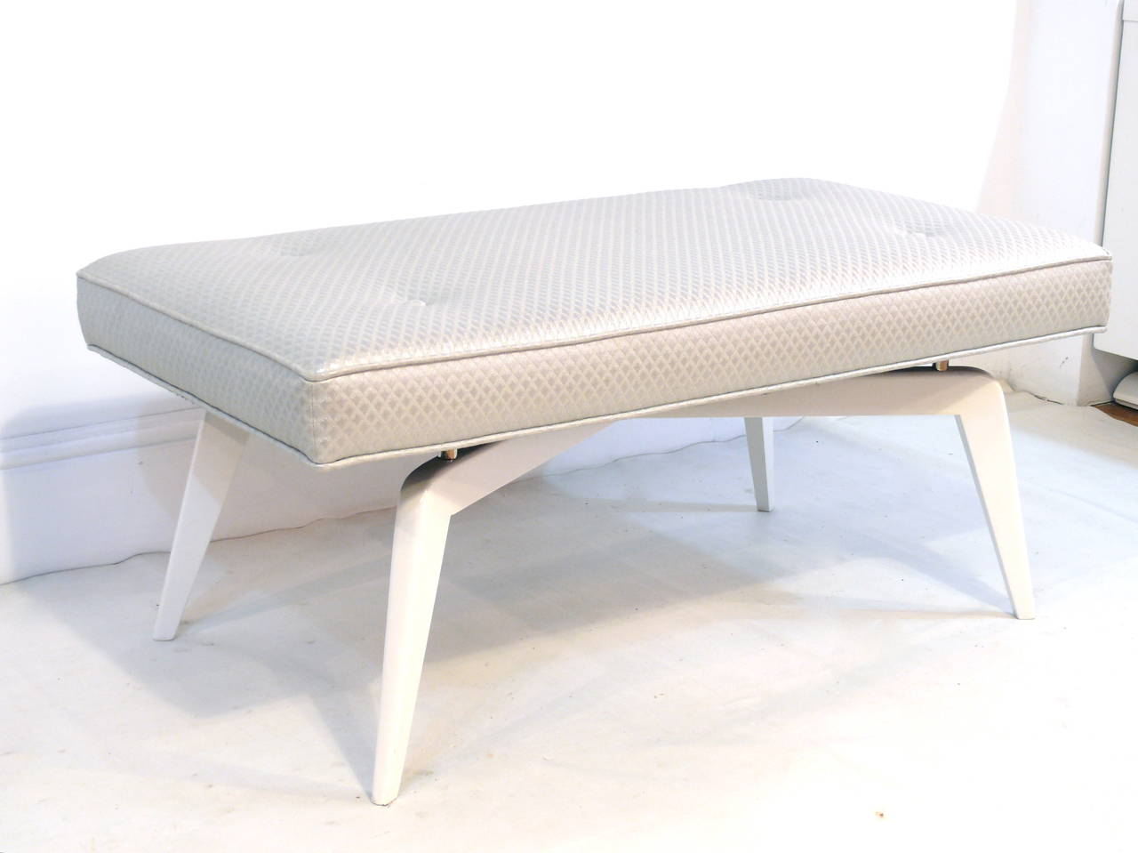 The elegantly appointed custom formation bench takes a step further. Designed by Irwin Feld design for CF modern, this evolved formation base boasts a clean and new sculptural 'X' shape. Shown here in a solid wood white lacquered base, custom nickel