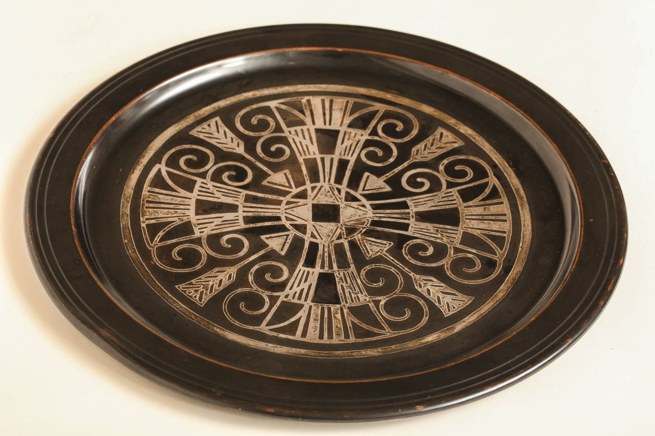 Large circular dinanderie tray with silver geometric design.

Impressed CHRISTOFLE  B3I

Literature: 
Dominique & Marie-Cecile Forest, 