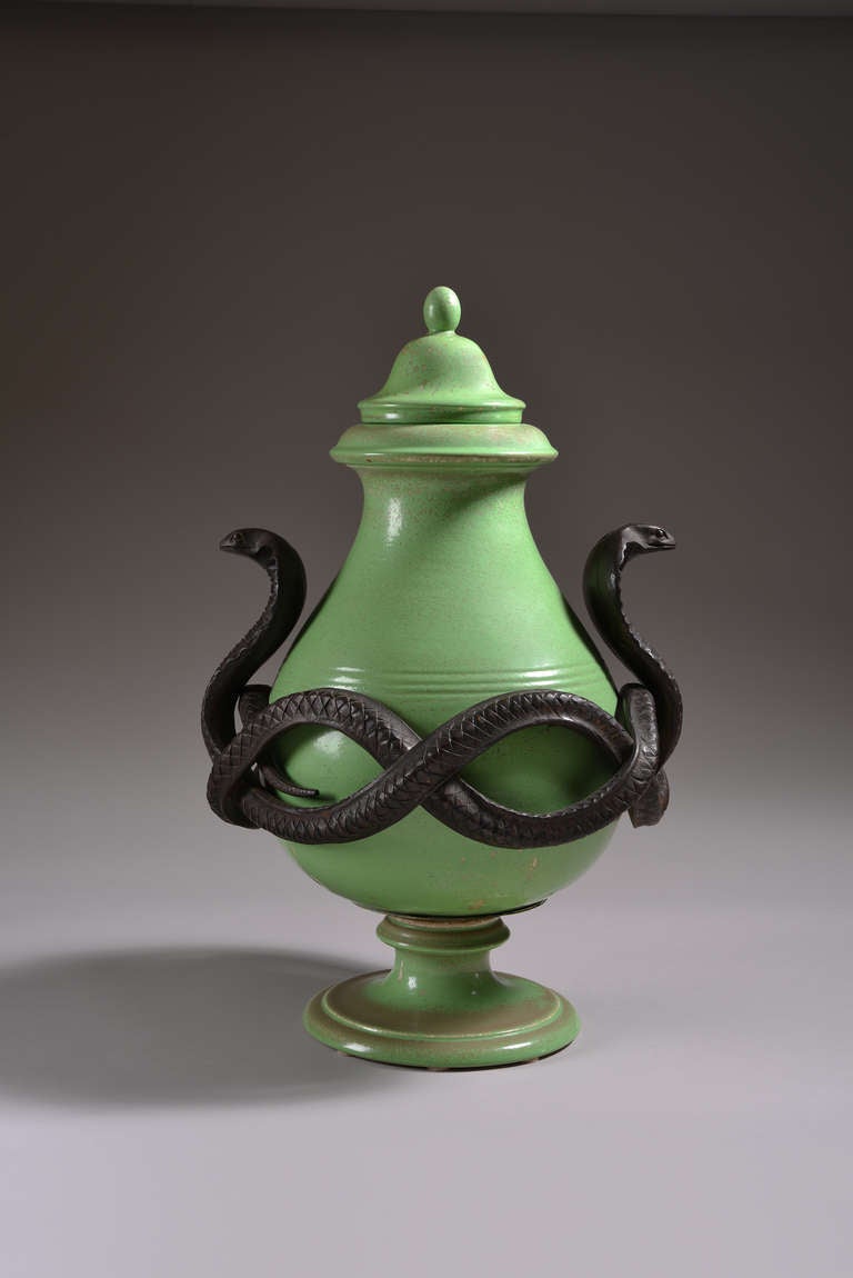 This large green covered jar by Sèvres sits on a foot stand and has a bronze mount cast as a coiled cobra on each side.
Signed: Impressed Sèvres 43 and inscribed 