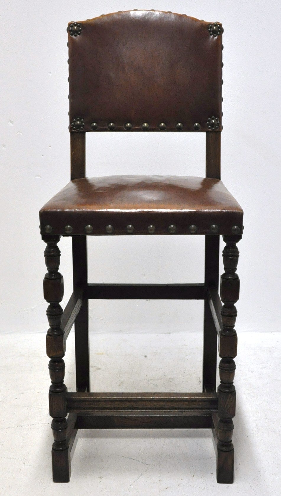 Set of 6 bar stools covered with original leather and brass nails (c:1900). These stools can be sold separately.