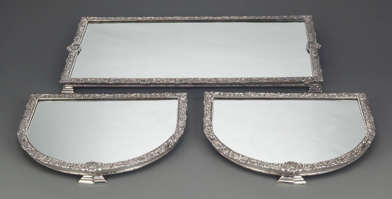 Elegant antique silver plated "surtout de table" from England, signed Sheffield and dated 1863, featuring a Pryor Tyzack & Co oval mirrored plateau in three sections with floral and shell borders to lip and reeded border to base, raised on