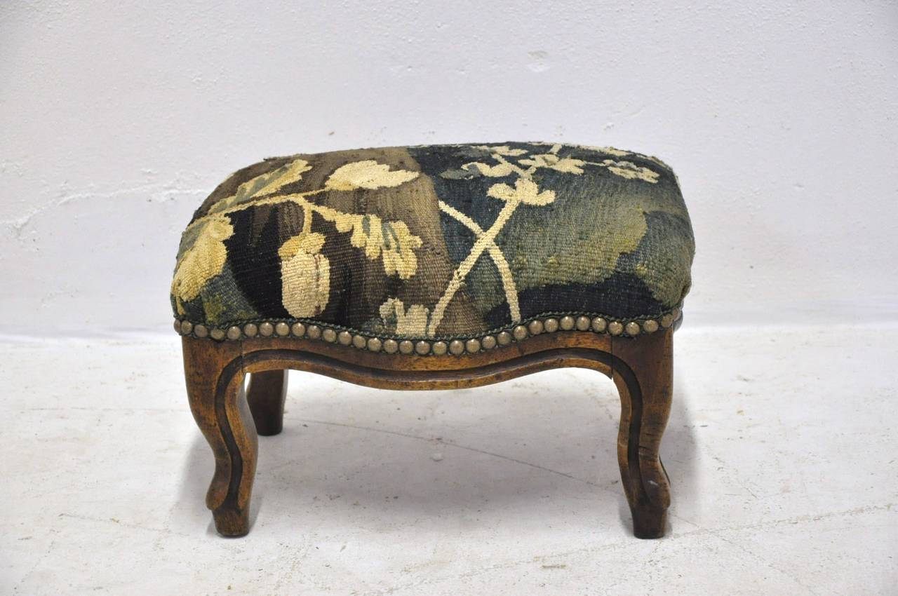 19th century Louis XV walnut foot stool recovered with 18th century Aubusson tapestry. New decorative nails and trim.