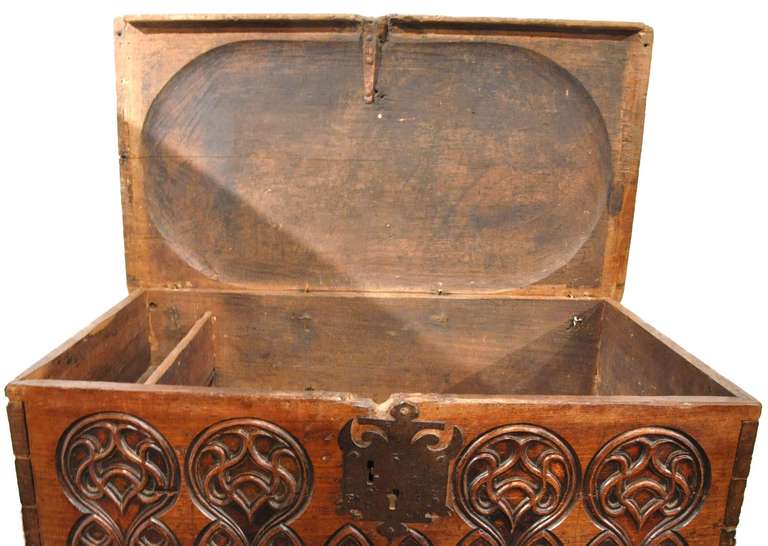 Fine 18th century walnut Gothic trunk with deep carving across the front and slightly bombe top (circa 1780).