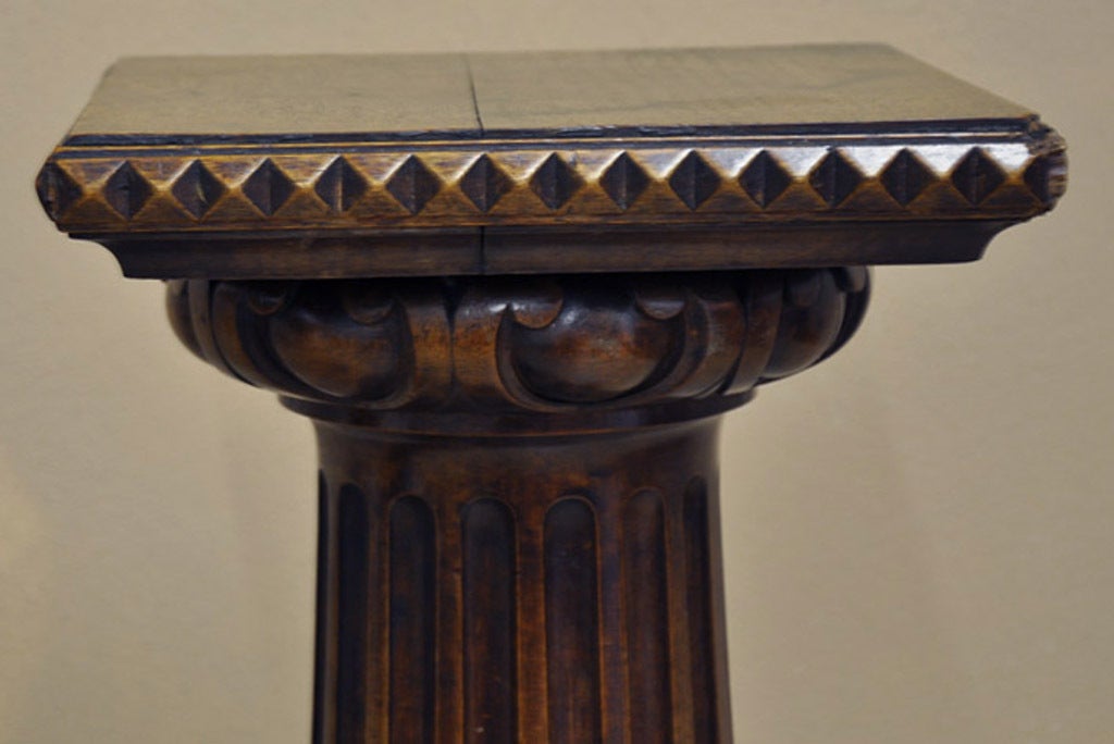 Pair of Early 19th century walnut pedestals.  Beautifully carved decorative columns resting on a square plinth. The top is 11.5