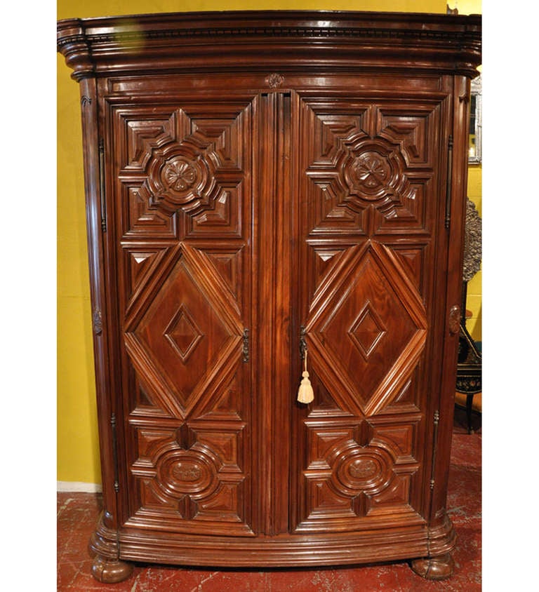 Elegant antique carved fruitwood armoire from the Southwest part of France, circa 1780. This piece features a structure with bold contours and deep relief moldings, yet, overall graceful geometric lines. The armoire has a triple stepped out