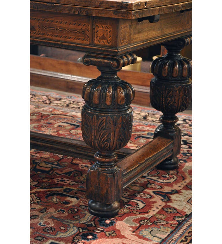 18th century English Oak Jacobean style Draw Leaf Refectory Table. table expands from 8 to 12 feet in length when leaves are pulled out.  Beautiful inlay work all around the apron. Table has been raised to accommodate modern seating.