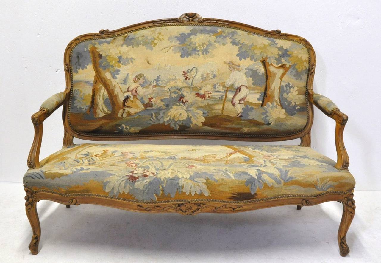 Three pieces 19th century Provencal salon including a pair of armchairs with the matching canape, circa 1860. All pieces are upholstered with original Aubusson tapestry depicting pastoral scenes and young peasants.
Armchairs dimensions: 29 W x 21 D