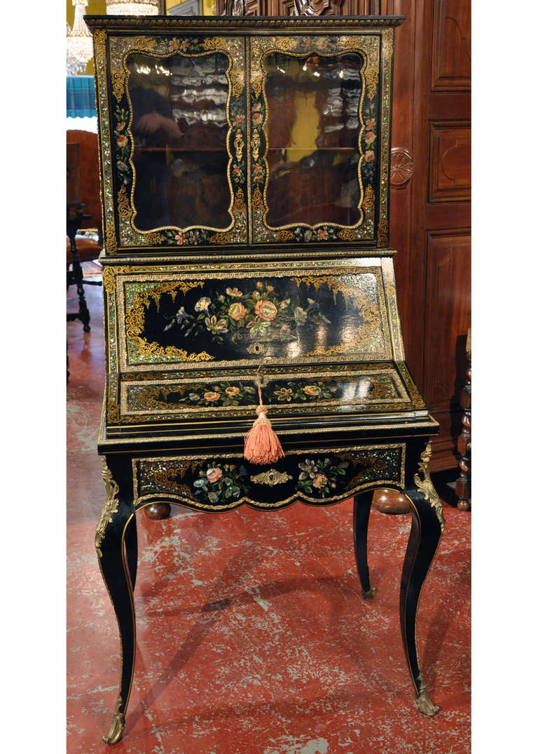 This beautiful, antique "Bonheur du Jour" was crafted in France circa 1870. The feminine lady's writing desk is delicate and decorative throughout. The secretaire is black lacquer with a mother-of-pearl inlay and painted floral motifs. The