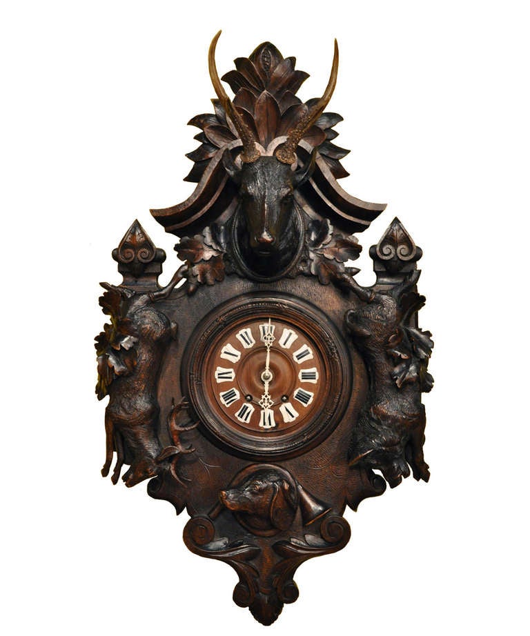 Fabulous matched pair of 19th C. carved black forest block and Barometer  in a hunting motif.  Each features a carved deer head mounted with roe deer antlers.  The clock features a large stag and boar on the sides, with a dog head at the bottom,