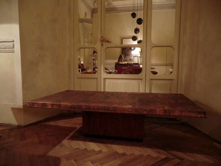 low coffee table covered in hammered copper