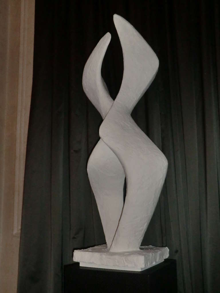 Tall  sculpture layered in white plaster