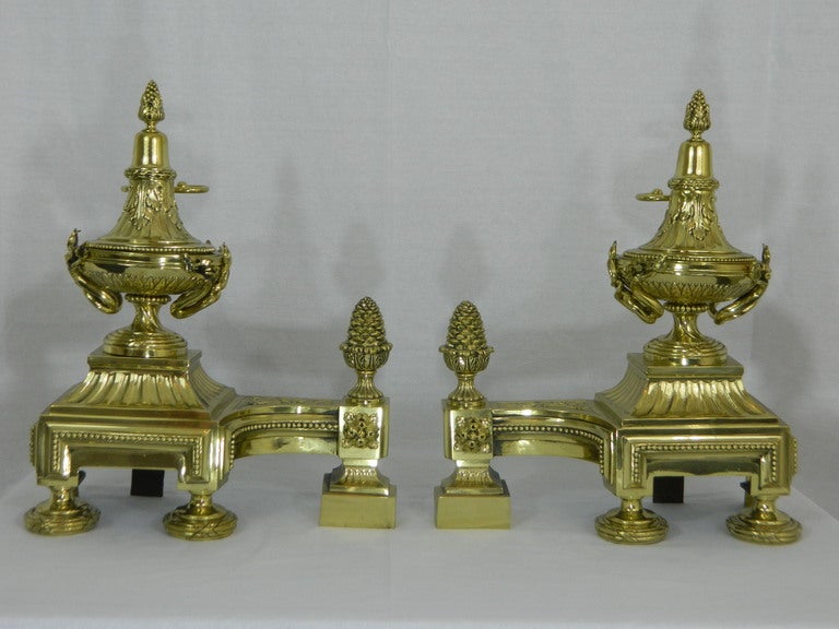 19th century pair of chenets or andirons with urns motif and acorn finials.