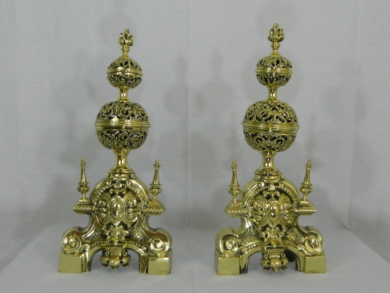Pair of 19th century chenets or andirons with a flame finial and two decorative pierced or reticulated balls.