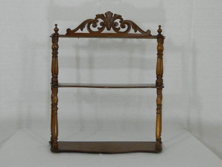 Early 19th century French mahogany what not three-tier wall hanging shelf with carved poles.