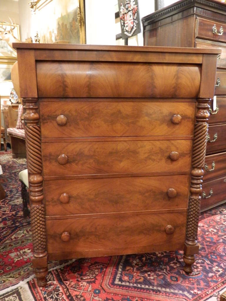 Late 19th century five drawer federal chest on turned feet with decorative pilasters consisting of a carved rope detail and a honeycomb pattern throughout