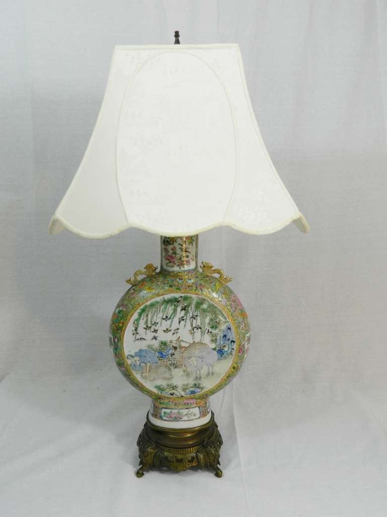19th century rose medallion Chinese porcelain lamp in an unique shape on a bronze base and a custom shade.