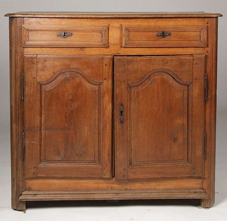 18th century French carved walnut buffet having two drawers over two raised panel doors.