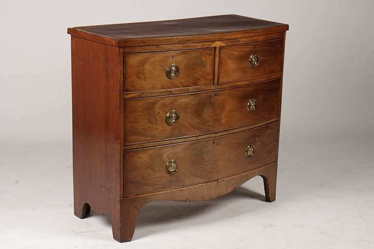 19th century Georgian bow front chest with banded top having two over two drawers raised on bracket feet.