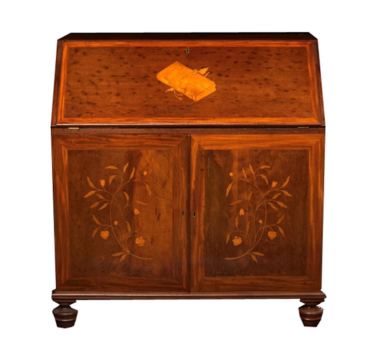 George III mahogany Bureau, the slant front with satinwood banding and central book inlay, opening to a leather-inset writing surface and a variety of drawers and cubbyholes flanking a central cupboard, over two cabinet doors, each inlaid with a