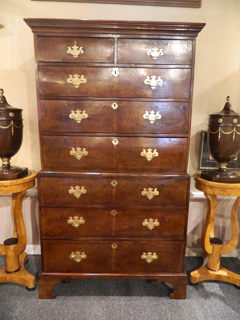George III walnut and mahogany chest on chest, the molded cornice above two short drawers and three graduated long drawers, the lower section also fitted with three graduated long drawers, all the drawers banded, raised on bracket feet. New