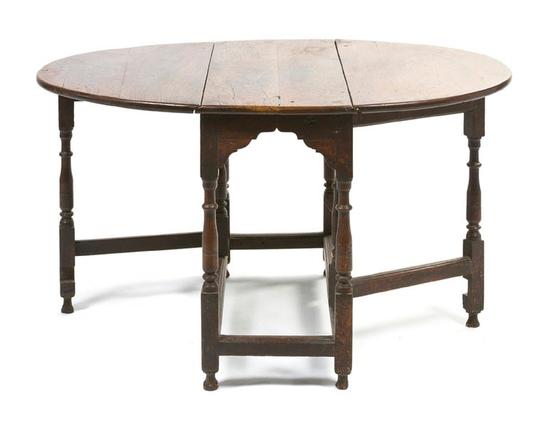 18th Century William and Mary Style Oak Gate-Leg Table, having a rectangular top with rounded ends over two demilune leaves, raised on a series of turned legs, joined by stretchers.  Length when fully extended is 49