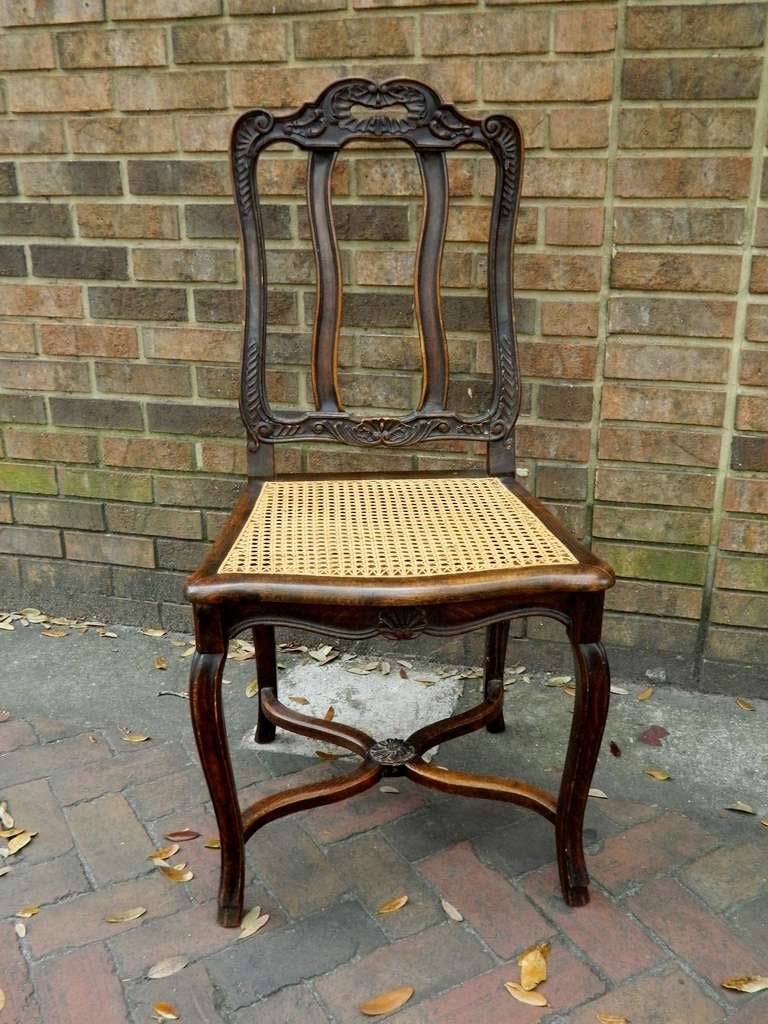 19th century set of eight oak Regence Style dining side chairs with cane seats.