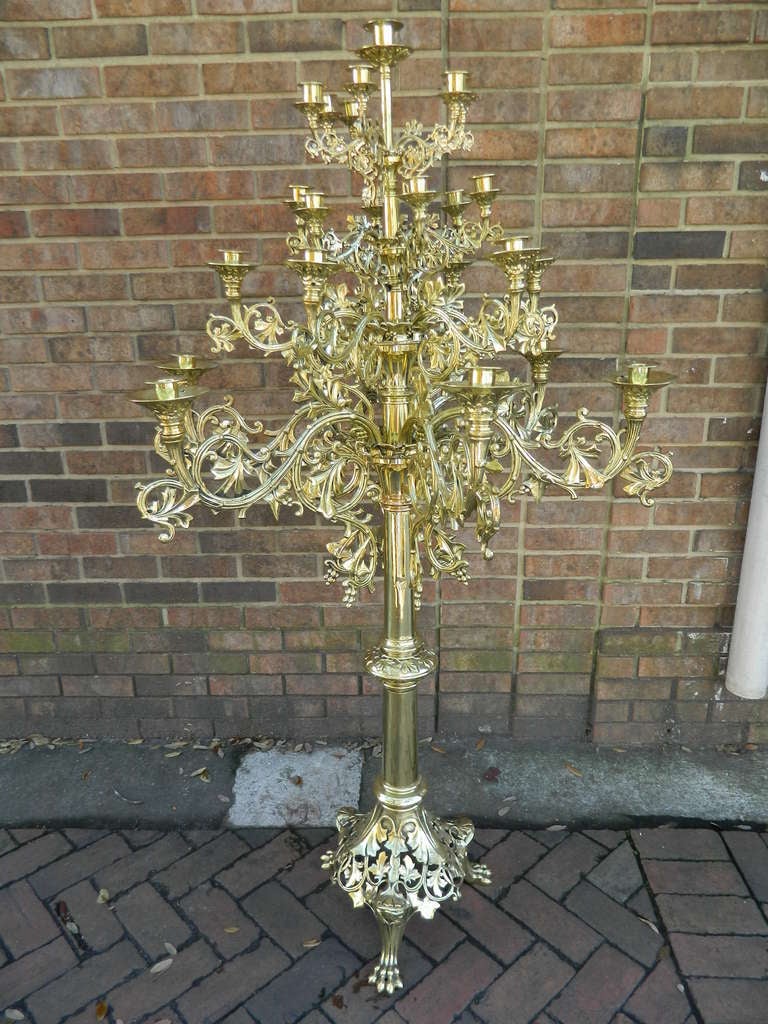 Circa 1860 Pair of Large Floor Standing Twenty Five Candle Candelabras Adorned with Scrolls and Ending on Reticulated Bases and Pad Feet.  They could easily be electrified