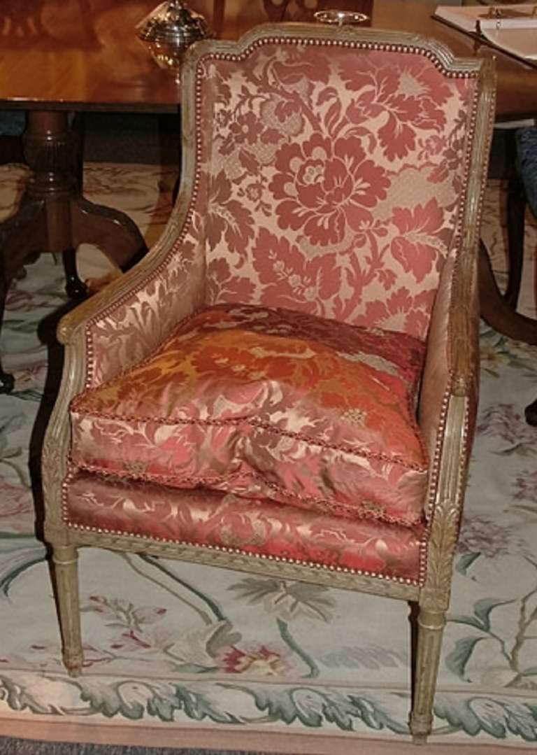 Early 20th century Louis XV style painted bergere or chair on tapered fluted legs. New silk upholstery and trim with down cushion insert.