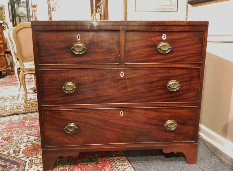 Circa 1820 Regency inlaid small mahogany chest of drawers with ivory keyholes, Brass Hardware, and Black Ebonized Banding
