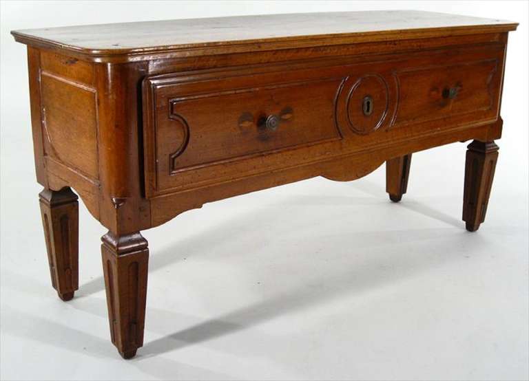 19th Century Renaissance Revival Style Walnut Low Commode, rectangular top with rounded corners, paneled long drawer with old paper lining, on square fluted tapering legs
